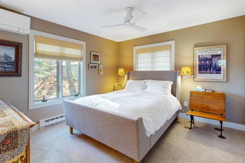 a bedroom with a large bed and a window at Saltbox 2A in Quechee