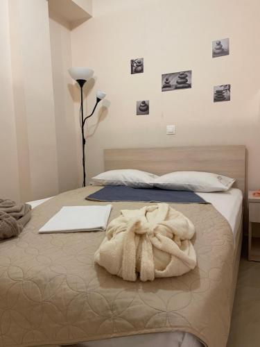 a bedroom with two beds with towels on the bed at G&M Luxury Studios in Thessaloniki