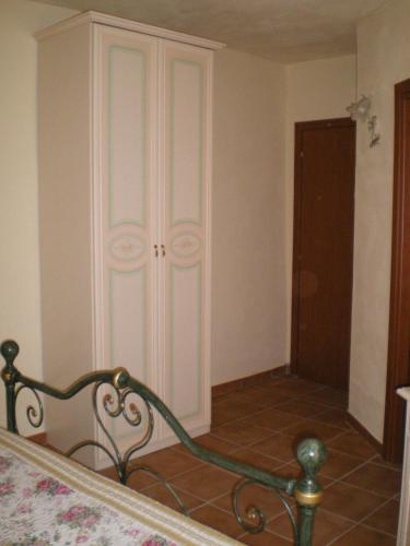 a bedroom with a white closet and a bed at Villa RosaMaria in San Chirico Raparo