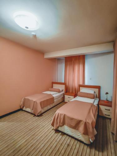 a room with two beds in a room at Motel Almy in Zenica