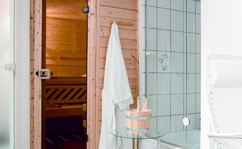 a bathroom with a shower with a table and a towel at Hotel & Restaurant Rosenthal Casino in Selb