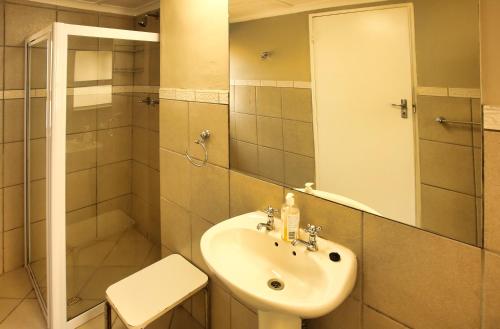 a bathroom with a sink and a shower at Holiday Home Seemansrus in Langebaan