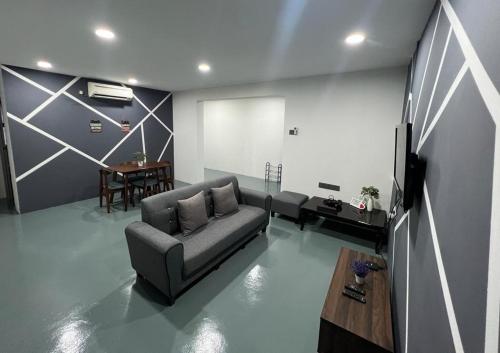 a living room with a couch and a table at GD HOMESTAY in Kulai