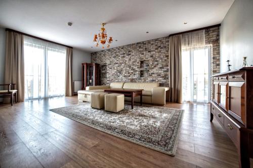 a living room with a couch and a table at Hotel Pan Tadeusz in Osielsko