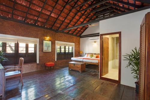 a bedroom with a bed and a table in a room at Niyati - Boutique Stay in Cochin