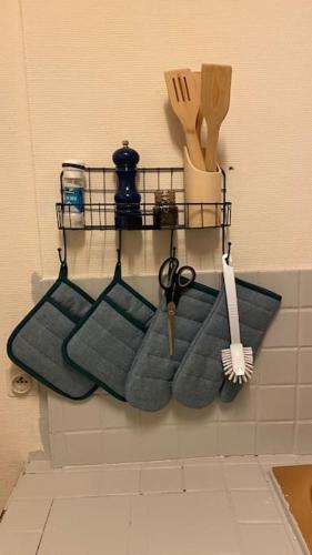 a rack of towels and utensils on a wall at Charmant appartement dans l’Orne ! in Vimoutiers