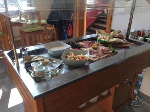 a buffet with different types of food on a counter at HOTEL Bahnhof Balingen in Balingen