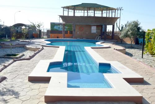 a swimming pool in a resort with a gazebo at Jabal Al Akhdar Grand Hotel in Jabal Al Akhdar