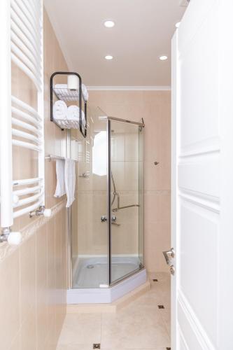 a bathroom with a shower with a glass door at Rose Hotel Vake in Tbilisi City