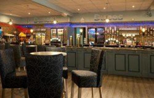 a bar with chairs and a table in a restaurant at Caravan Sleeps 4 with Free Parking in Burnham on Sea