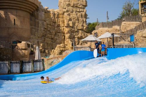 a group of people on a water slide at the theme park at Jumeirah Emirates Towers in Dubai