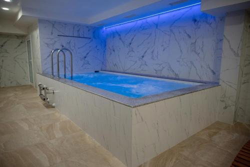 a bathroom with a tub with blue lighting at Lime house in Kyustendil
