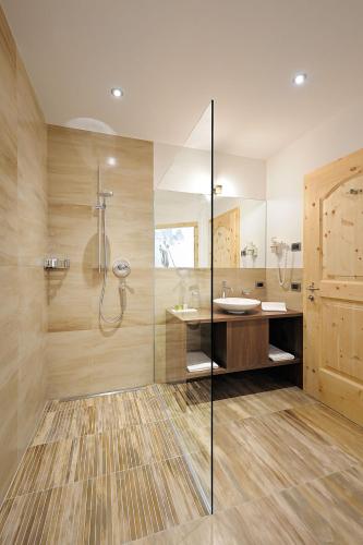 a bathroom with a shower and a sink at Garni Residence Soraiser in Selva di Val Gardena