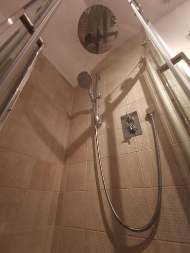a shower in a bathroom with a shadow on the floor at Prime location for Snowdon, Family and Dog friendly! in Llanberis