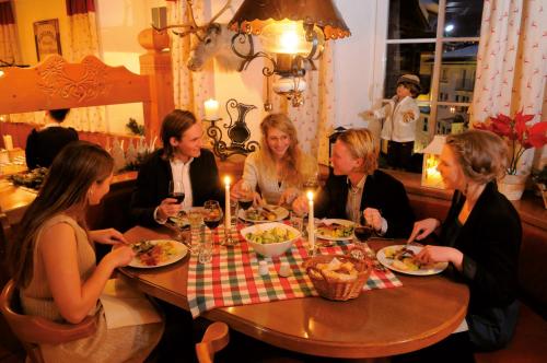a group of women sitting at a table eating food at Hotel Gisela in Bad Gastein