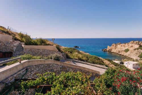 a set of stairs leading down to the ocean at Mikra Bay Vineyard Guesthouses in Naxos Chora