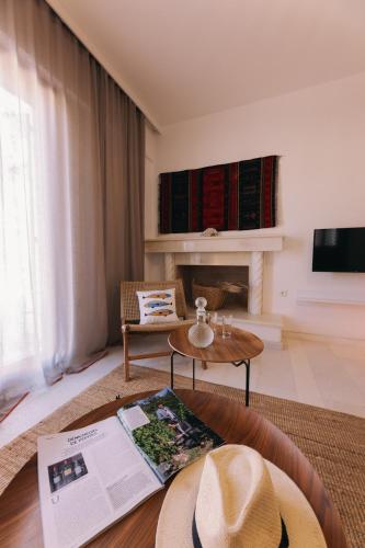 a living room with a hat on a table at Mikra Bay Vineyard Guesthouses in Naxos Chora