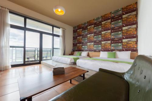 a hotel room with two beds and a couch at 時光輕旅 Time INN in Hengchun