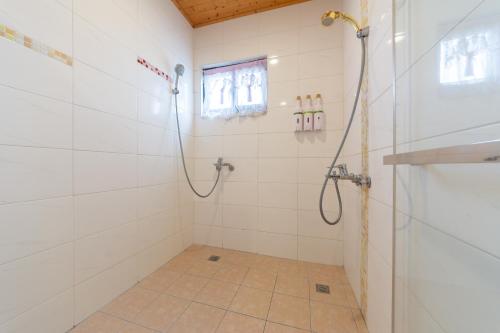a bathroom with a shower with a glass door at 時光輕旅 Time INN in Hengchun