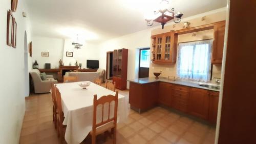 a kitchen and a dining room with a table and a kitchen at Casa Rural Doña Catalina in Jimena de la Frontera