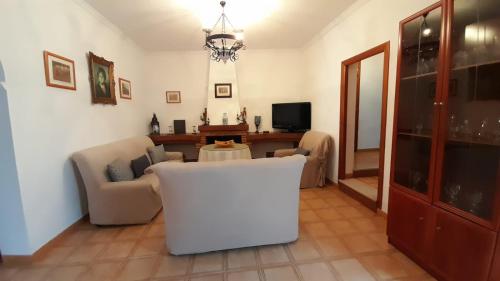 a living room with a couch and a table at Casa Rural Doña Catalina in Jimena de la Frontera