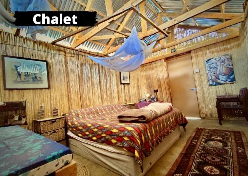 Dormitorio con cama y red en Eselbe Camp Backpackers en Nata