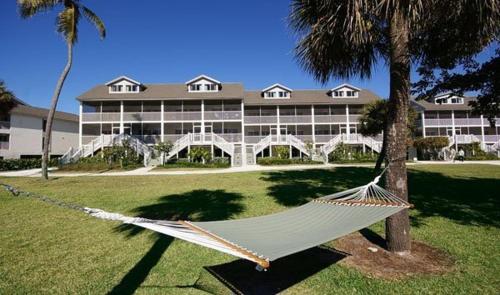 a hammock in front of a large building at Casa Ybel Resort in Sanibel