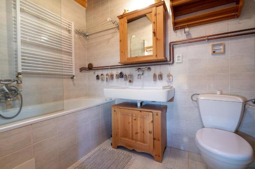 e bagno con lavandino, servizi igienici e vasca. di Traditional cozy cottage BOCANKA a Nižná Boca