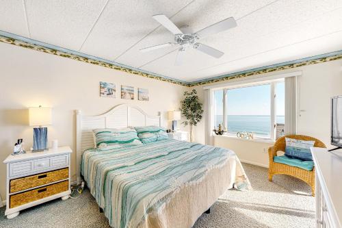 a bedroom with a bed and a window with the ocean at Blue Sea Colony 501 in Ocean City