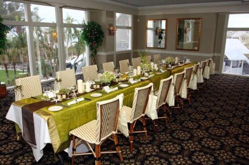 a long table in a room with white chairs at Casa Ybel Resort in Sanibel