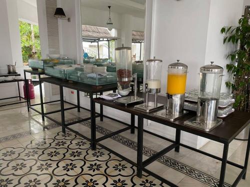 a table with some glasses and some drinks on it at Private Luxury Villa in private beach resort in Telukmataikan