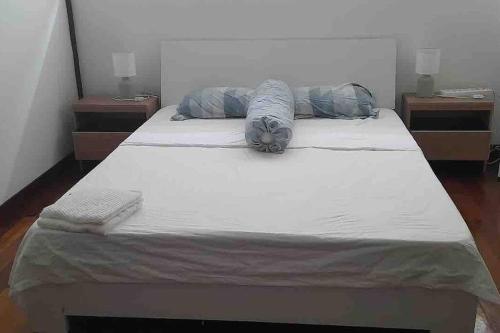 a large bed with two pillows on top of it at Private Luxury Villa in private beach resort in Telukmataikan
