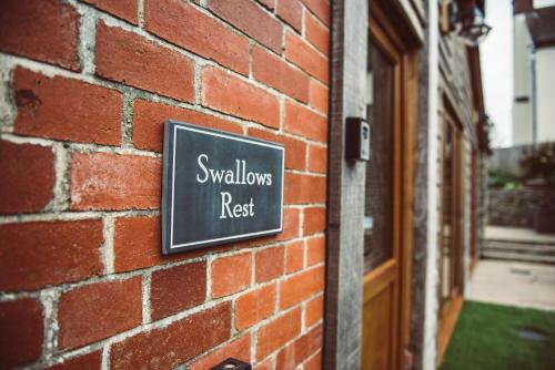 a sign on the side of a brick building at Swallows Rest in Montgomery