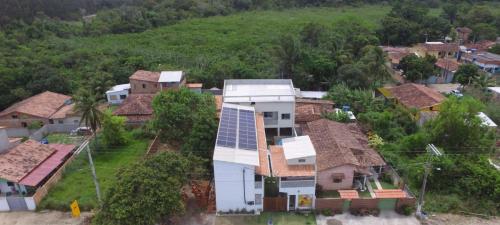 an aerial view of a house with solar panels on its roof at Pousada Sonho Meu in Itaúnas