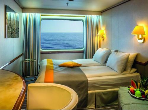 a room with two beds and a window on a ship at yatch ltd. in Silivri