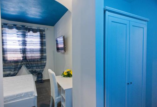 夏卡的住宿－B&B Lido Esperando Sciacca，一间设有蓝色门的房间和一张桌子