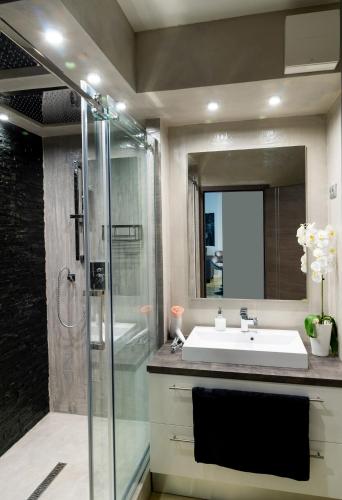 a bathroom with a sink and a shower at Dream Apartman 3 with Free Parking in Győr