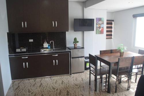 a kitchen with a table and a dining room at Avana Hills Tagaytay Villa in Tagaytay