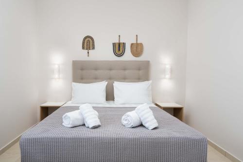 a bedroom with a bed with two white towels at Symphony Residence in Vóthon