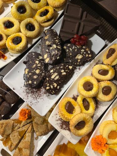 a display of different types of donuts and other desserts at Villa Abbondanzi Resort in Faenza
