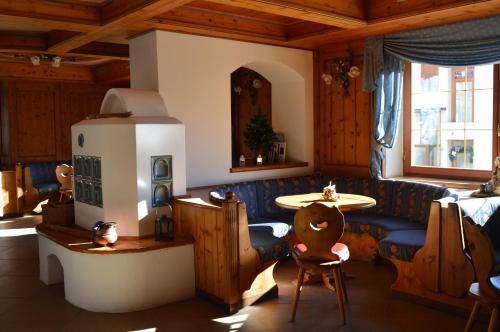a living room with a blue couch and a table at Hotel Villa Aurora in San Martino di Castrozza