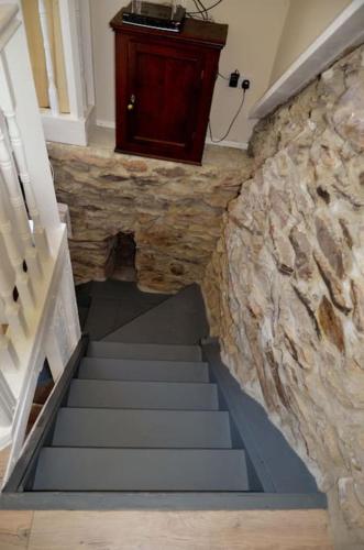 a staircase in a building with a stone wall at Secluded cottage nestled in the Beara Peninsula in Killarney