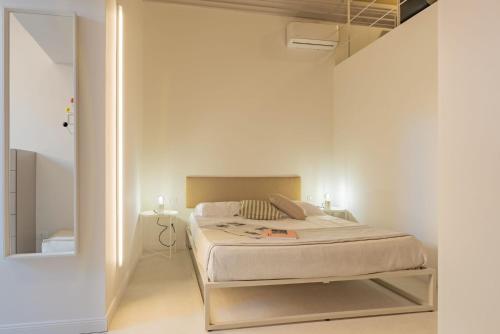 a bedroom with a bed in a white room at CA'DUPELLE in Loano