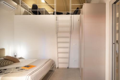 a room with a bed and a staircase in it at CA'DUPELLE in Loano