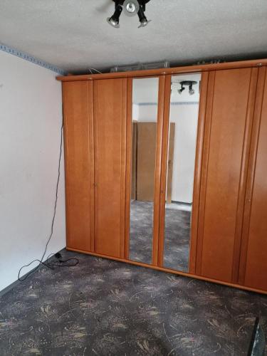 a closet with a mirror in a room at SleepArt-Naumburg 