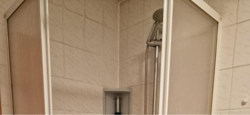 a shower with a glass door in a bathroom at SleepArt-Naumburg 