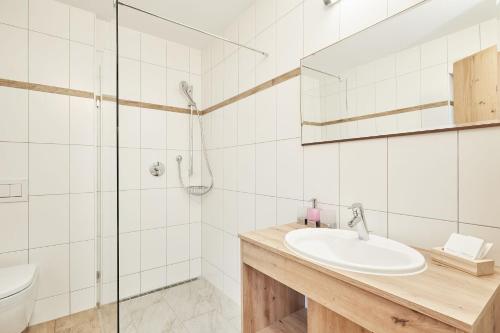 a bathroom with a sink and a shower at Landhotel Berger in Ainring