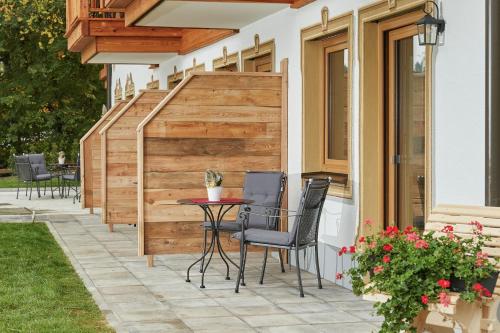 a patio with chairs and a table and a fence at Landhotel Berger in Ainring
