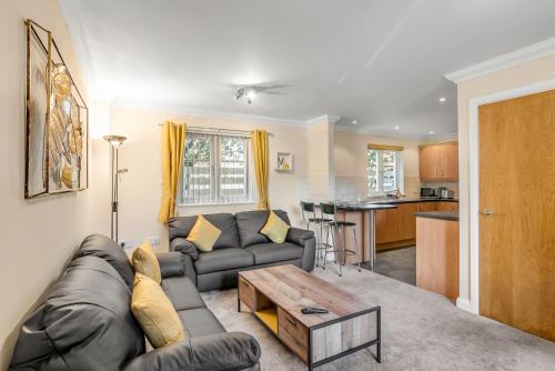 a living room with a couch and a table at Central Townhouse 2 Bedr W Fully Equipped Kitchen Washing Machine & Parking- Ginger & Gold Ltd in Norwich