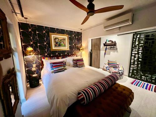 a bedroom with a large bed and a ceiling fan at Forty 4 On Hoog in Polokwane